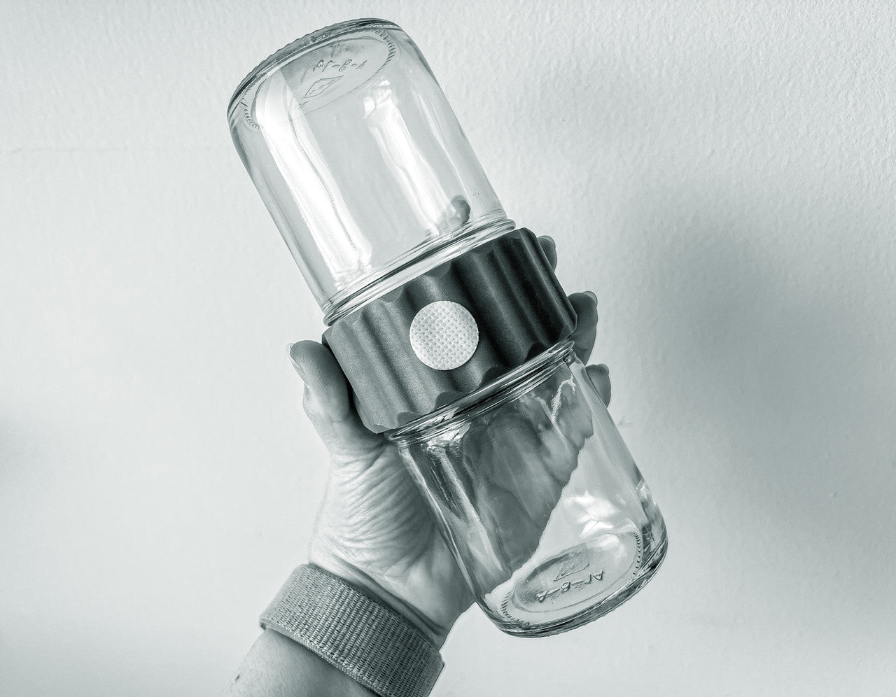 Glass BioCoupler set in hand, front view.