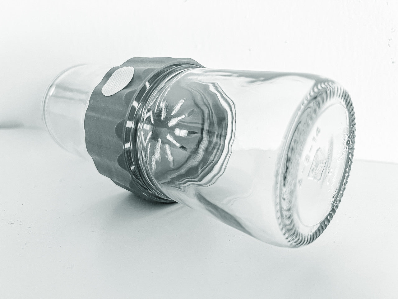 Side  view image of the glass BioCoupler set laying on a flat surface.