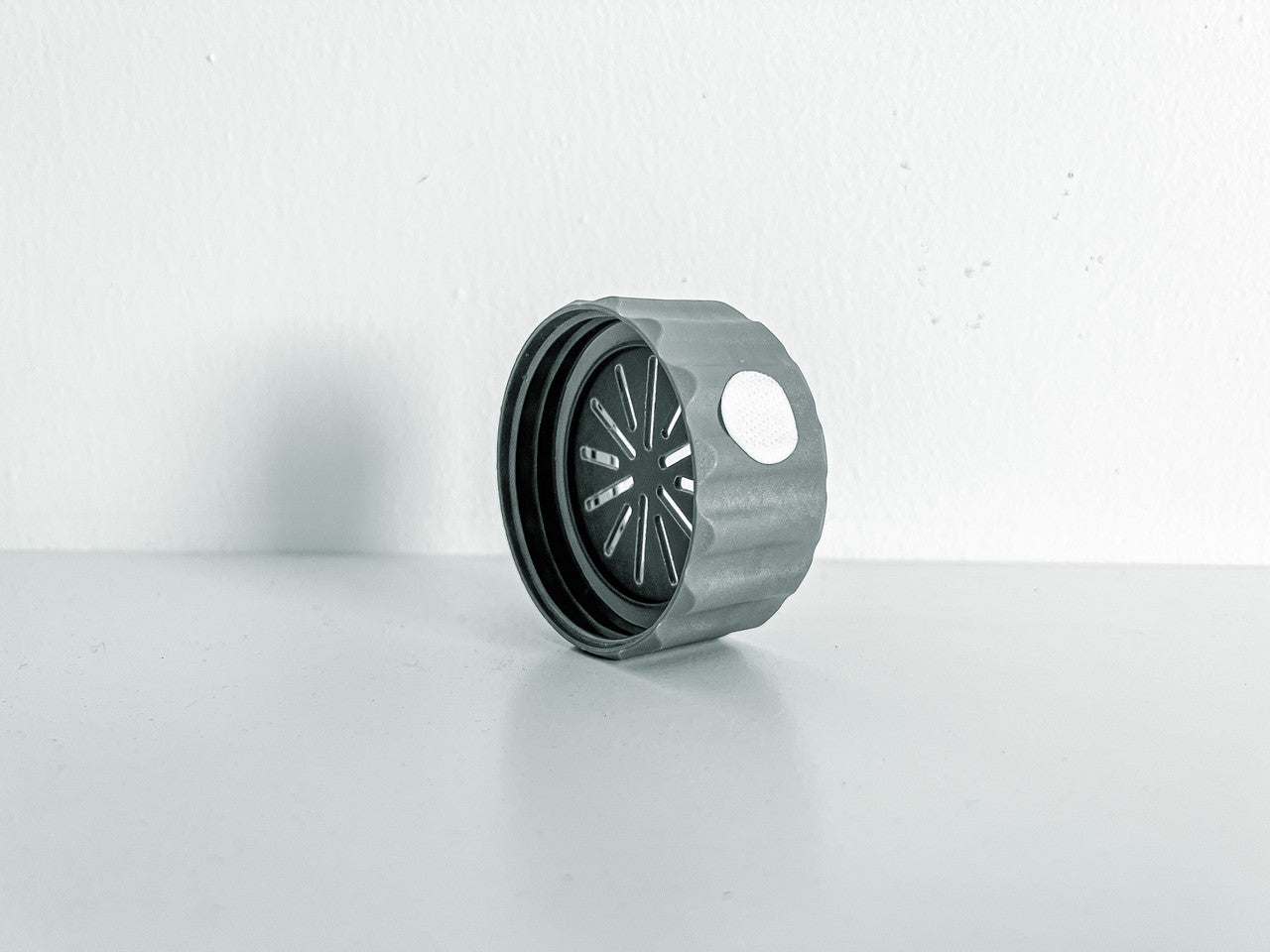 Image of a singular BioCoupler on its side taken from an angle.